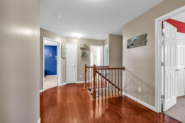 corridor with dark hardwood / wood-style flooring