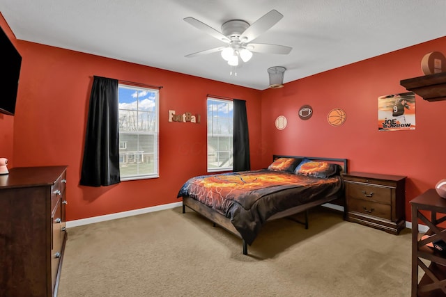 bedroom with light colored carpet and ceiling fan