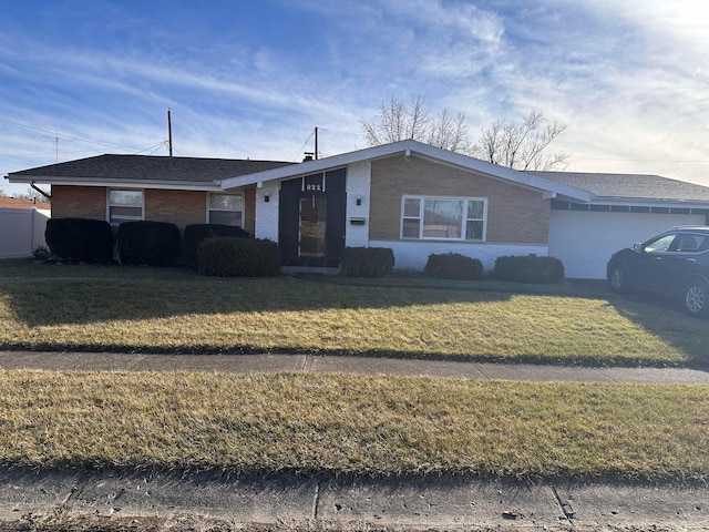 ranch-style home with a garage and a front lawn