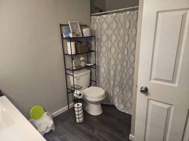 bathroom with hardwood / wood-style flooring and toilet