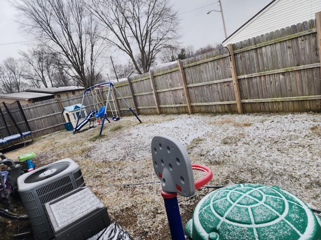 view of yard featuring a trampoline and a playground