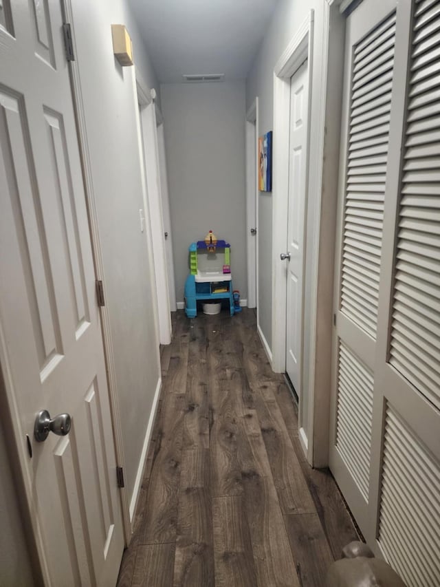 hallway with dark hardwood / wood-style floors