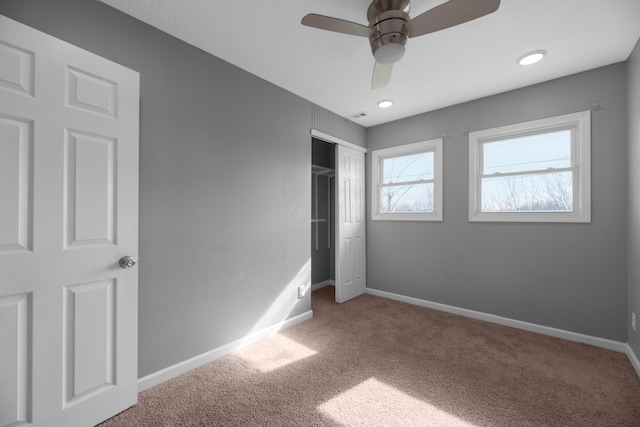 unfurnished bedroom featuring carpet floors, ceiling fan, and a closet