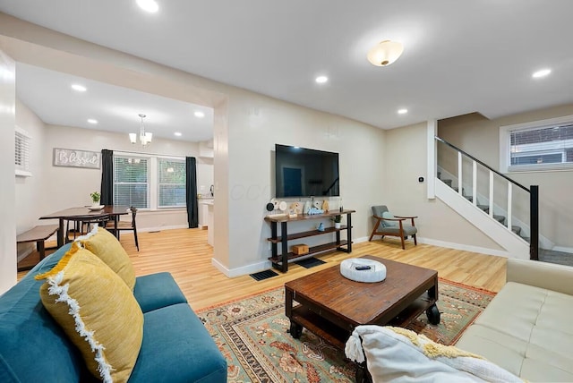 living room with hardwood / wood-style flooring and an inviting chandelier