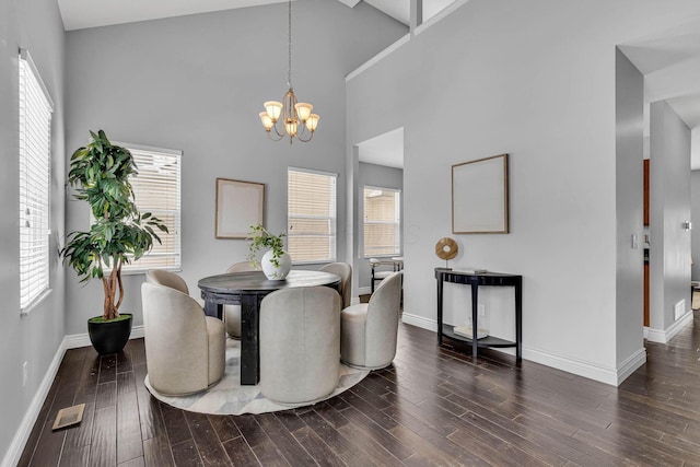 dining area featuring dark wood-style floors, a wealth of natural light, a chandelier, and visible vents