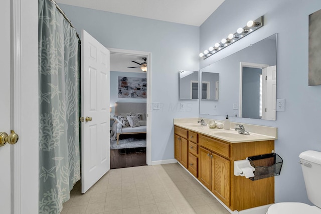 full bathroom with a sink, a ceiling fan, toilet, and connected bathroom