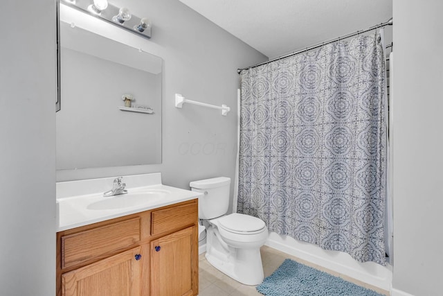 full bathroom featuring shower / bath combo with shower curtain, vanity, toilet, and tile patterned floors