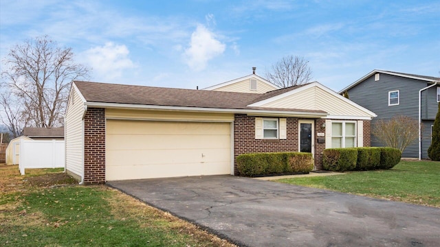 view of front facade with a garage and a front lawn