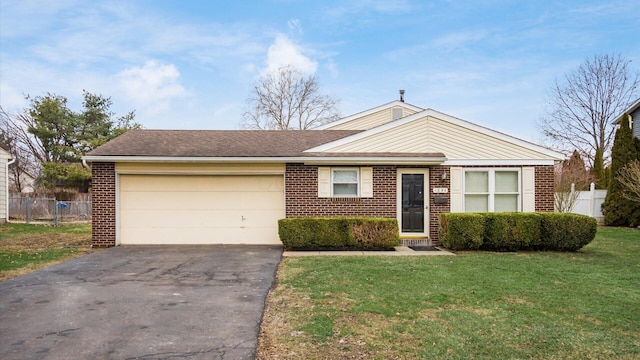 ranch-style home featuring a garage and a front lawn