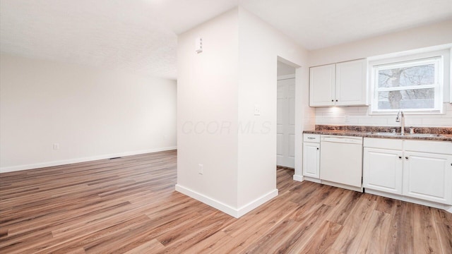 kitchen featuring white cabinetry, dishwasher, sink, and light hardwood / wood-style flooring