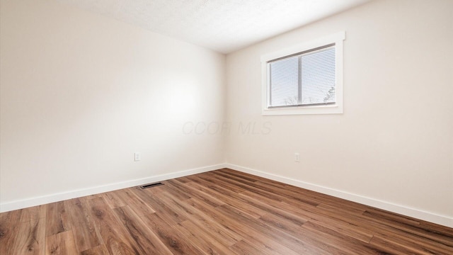 unfurnished room featuring wood-type flooring