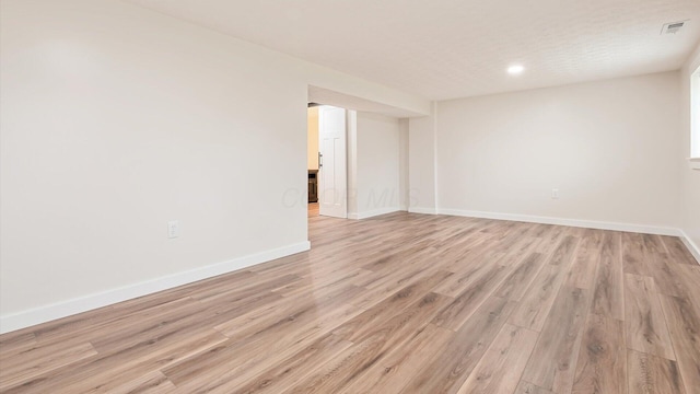 empty room with light hardwood / wood-style flooring