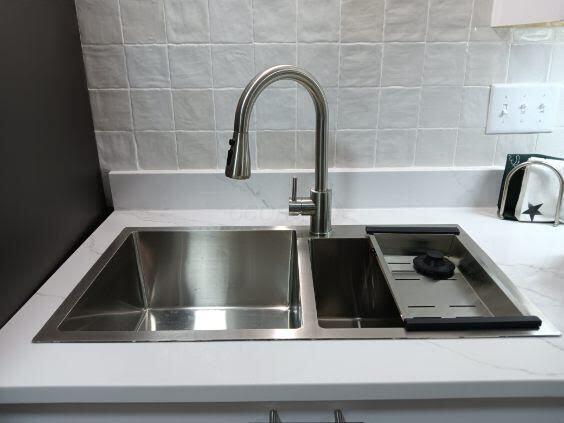 details featuring light stone countertops and sink