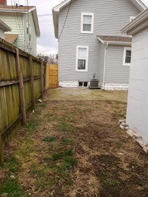 rear view of house featuring central AC