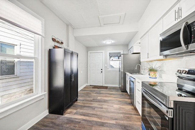 kitchen featuring white cabinetry, a healthy amount of sunlight, and appliances with stainless steel finishes