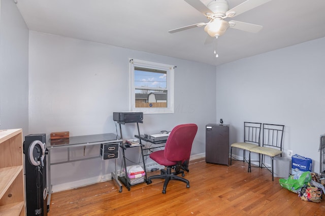 office featuring ceiling fan, baseboards, and wood finished floors