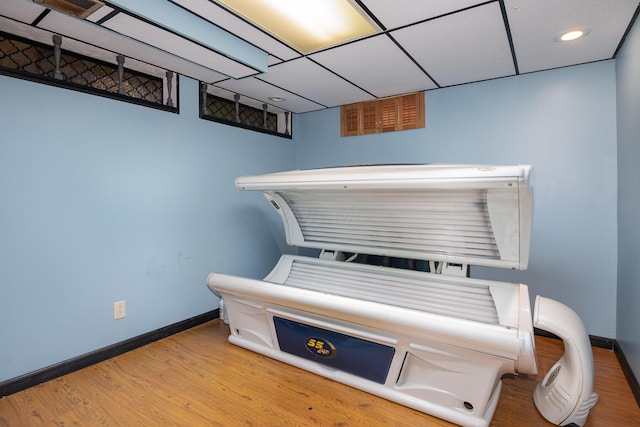 miscellaneous room with recessed lighting, wood finished floors, and baseboards