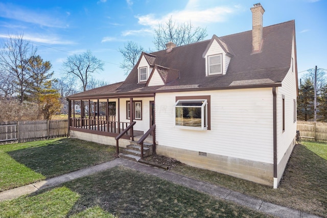 view of front facade with covered porch, fence, roof with shingles, a chimney, and a front yard