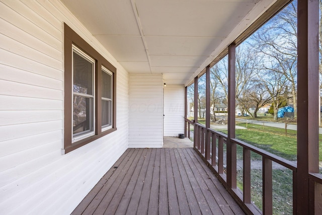 wooden deck featuring covered porch and a yard