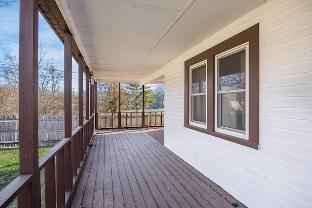 wooden terrace featuring fence