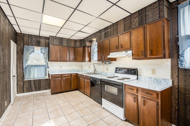 kitchen featuring black dishwasher, light countertops, a sink, range with electric cooktop, and under cabinet range hood