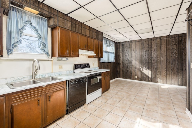 kitchen featuring light countertops, electric range oven, a sink, dishwasher, and under cabinet range hood