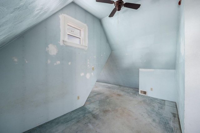 bonus room featuring lofted ceiling, visible vents, and light colored carpet