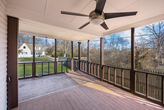 unfurnished sunroom with a ceiling fan