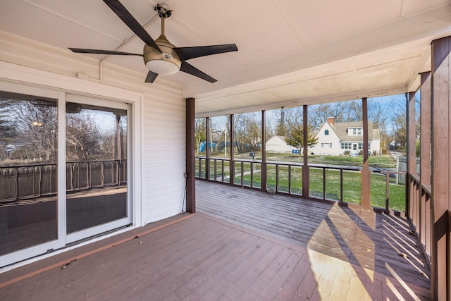 unfurnished sunroom featuring a ceiling fan