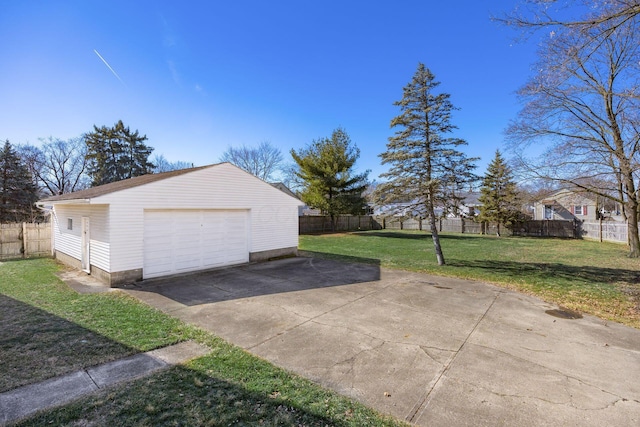 detached garage with driveway and fence