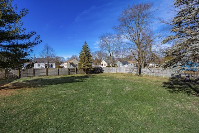 view of yard featuring a residential view and fence