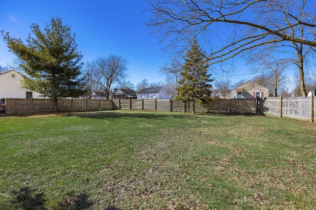 view of yard with a fenced backyard and a residential view