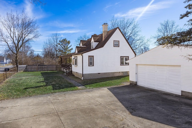 view of side of home featuring driveway, a garage, a lawn, a chimney, and fence