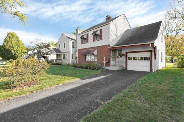 view of front of home featuring a front lawn, aphalt driveway, a garage, brick siding, and a chimney