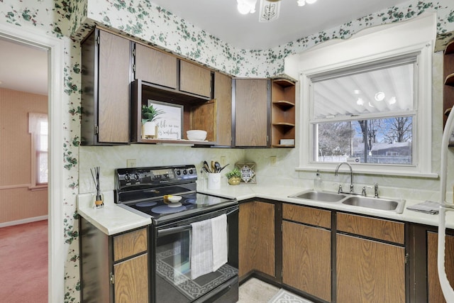 kitchen featuring a sink, open shelves, black electric range oven, and light countertops