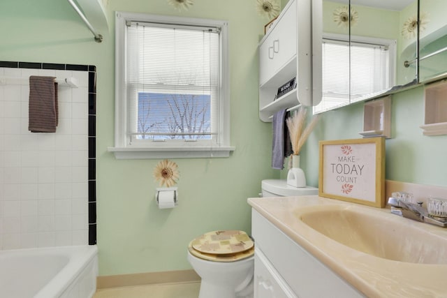 bathroom with vanity, shower / tub combination, toilet, and baseboards