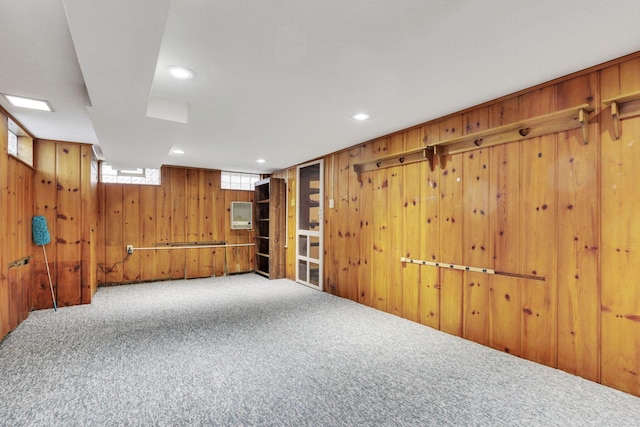 basement featuring recessed lighting, wooden walls, and carpet flooring