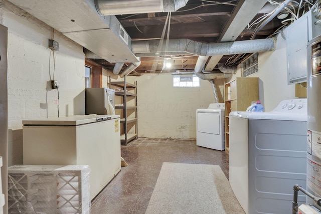 basement with white fridge and washer and clothes dryer