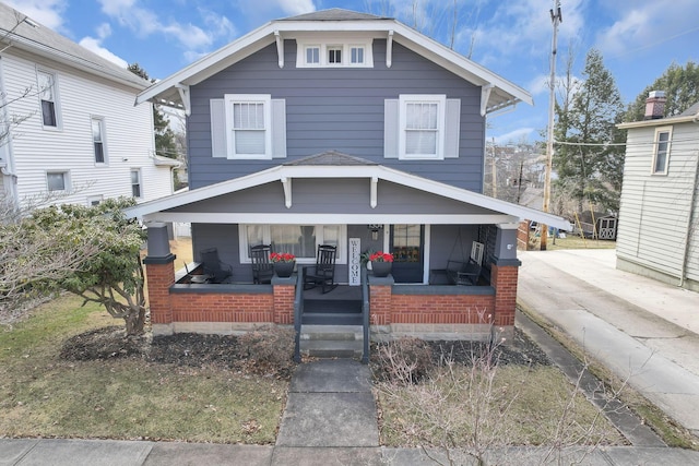 american foursquare style home with covered porch