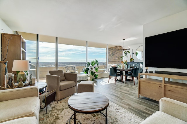 living room featuring an inviting chandelier and hardwood / wood-style floors