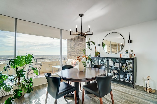 dining space with hardwood / wood-style flooring and a chandelier