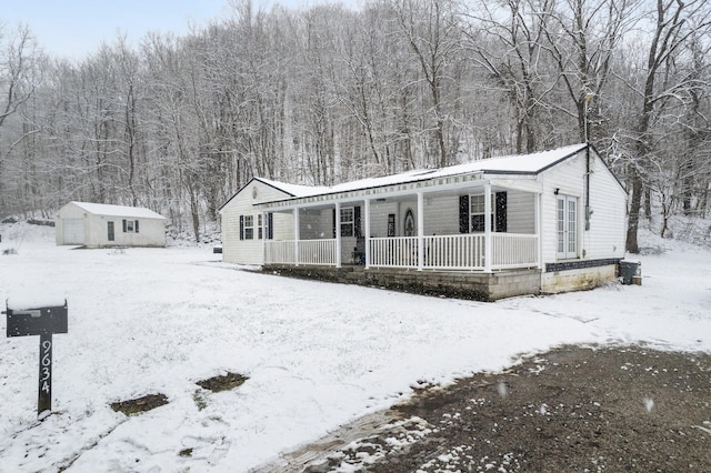 view of front of property with a storage shed and a porch