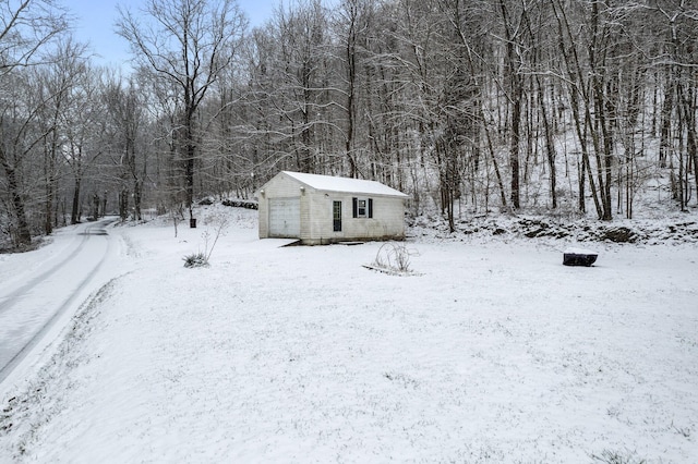 yard layered in snow featuring an outbuilding