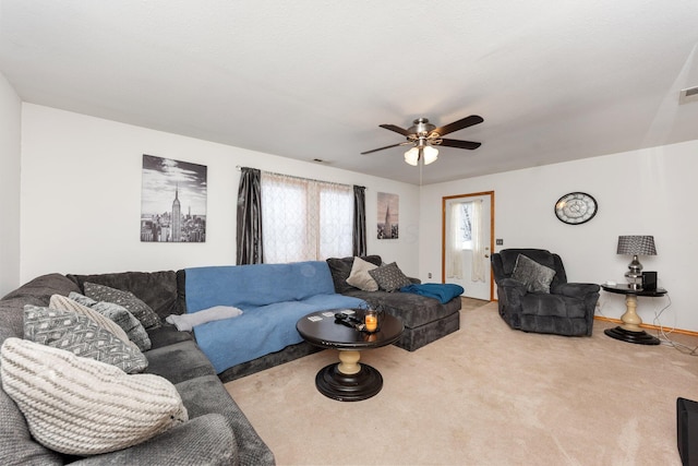 living room with ceiling fan and carpet