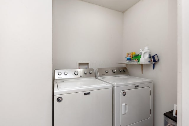 clothes washing area with washer and clothes dryer