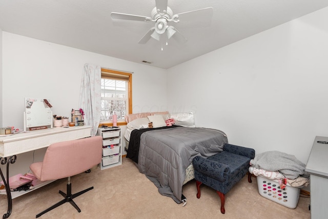 bedroom featuring light colored carpet and ceiling fan