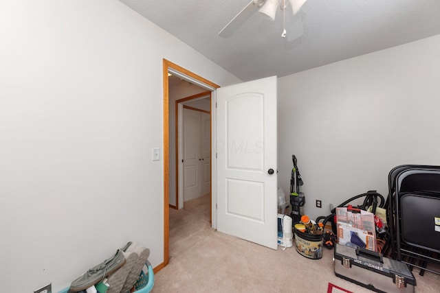 office with light carpet and ceiling fan