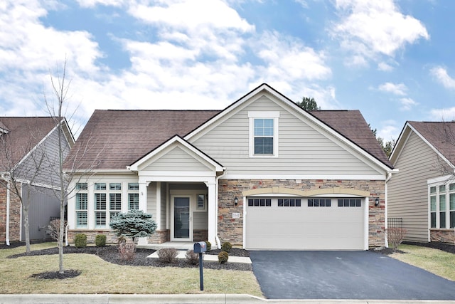 view of front of house featuring a garage and a front lawn