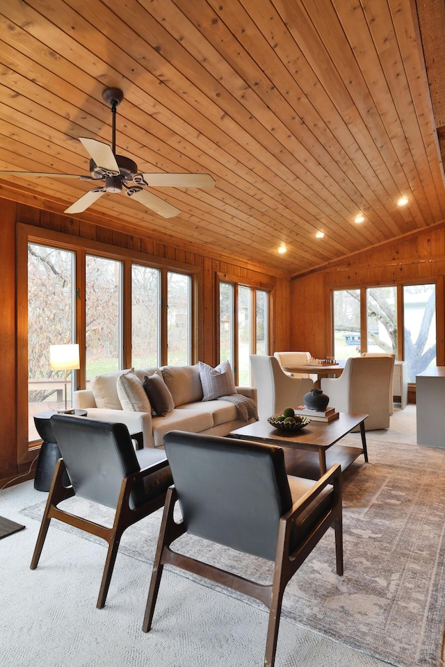 living room with light carpet, vaulted ceiling, wooden ceiling, and wooden walls