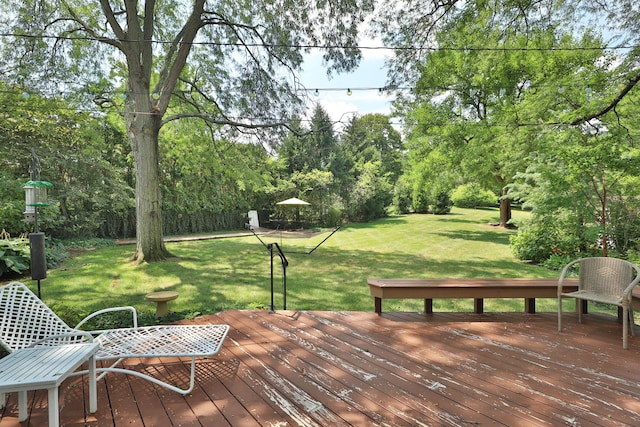 wooden deck featuring a lawn